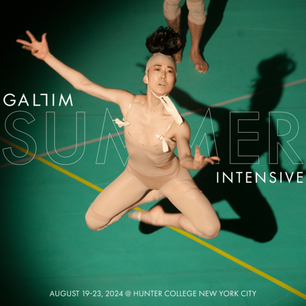 dancer jumping in front of text on a green stage 
