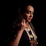 South Aisian woman wearing a deep red sari and beaded jewelry