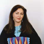 Diane wearing her Osage traditional blanket-dark blue wool broadcloth with silk ribbonwork Sunrise pattern