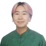 Melinda, a young East Asian person with chin-length bleached gray hair, is wearing a black turtleneck shirt and smiling