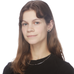 black and white photo of Madalyn, a white person with a bob haircut with bangs, in a white button down shirt, smiling.