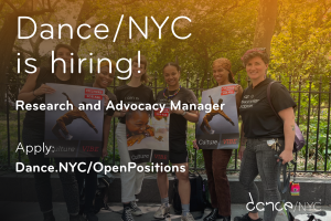 Photo of dance workers standing together, smiling, at an arts rally. standing in front . Text over the image reads ‘Dance/NYC is hiring! Research and Advocacy Manager. Apply: Dance.NYC/OpenPositions. The Dance/NYC logo rests in the bottom right corner.