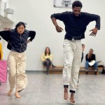Kinesis Project dancers Ryan and Yang jump lighly in unison in an open rehearsal