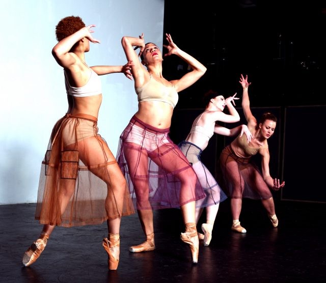 Four dancers posing in ballet style.