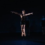 Male dancer jumping up, arms in 2nd position, legs in 5th position feet and hands stretched..                               