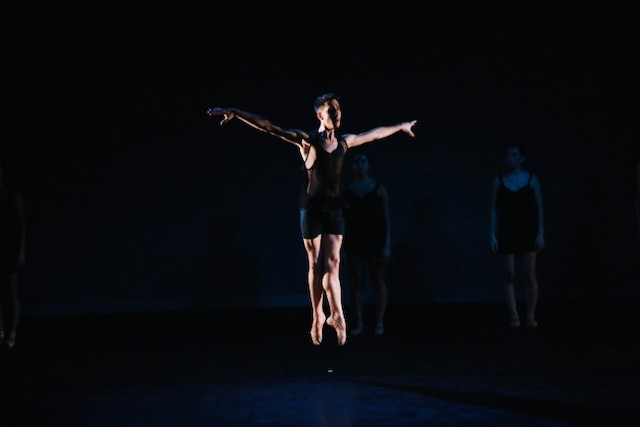Male dancer jumping up, arms in 2nd position, legs in 5th position feet and hands stretched..                               