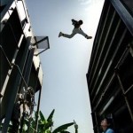 a twelve-year-old makes a daredevil leap from one freight care to another. He hopes to eventually reach San Diego.