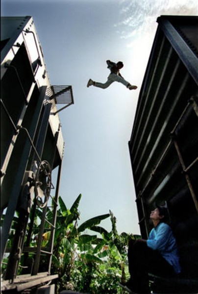 a twelve-year-old makes a daredevil leap from one freight care to another. He hopes to eventually reach San Diego.