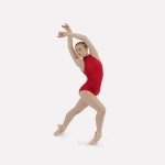 Dancer in a red leotard and pointe shoes