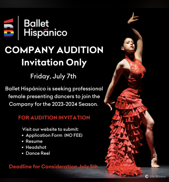 Dancer in red dress with hand up in the air