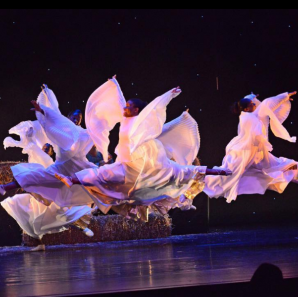 Dancers playing angels in The Nativity: Birth of a King leap across the stage.