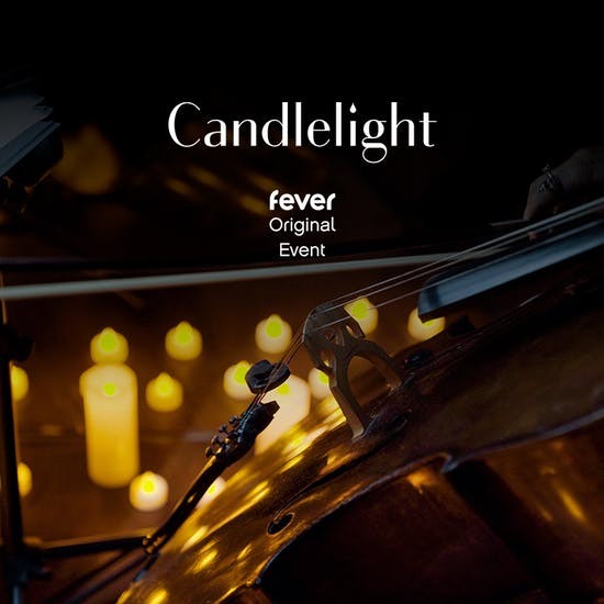 Dimly lit candles surrounding a violin, text reading "Candlelight, Fever Original Event" 