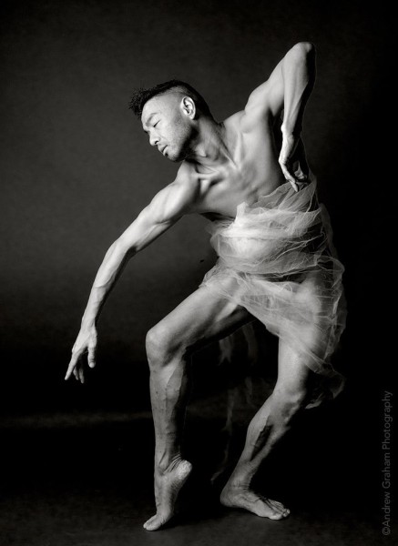Photo of an Asian male dancer in black and white posing. 