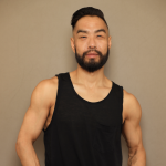 Peter Cheng, an Asian male-identifying dancer in a black tank-top.