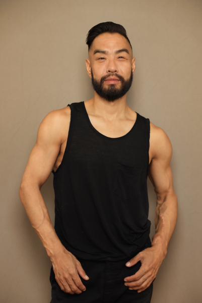Peter Cheng, an Asian male-identifying dancer in a black tank-top.