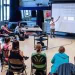 A professional development photo from a workshop at the 92nd Street Y. This photo shows a presenter and particpants. 