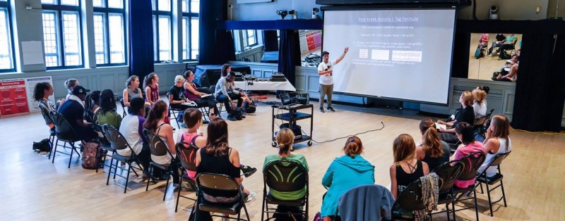 A professional development photo from a workshop at the 92nd Street Y. This photo shows a presenter and particpants. 