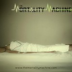 The Mortality Machine show poster. A female wrapped in a white sheet lies on a white bed hooked up to an IV and EKG.