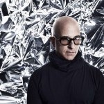 Stephen Petronio wearing large sunglasses in front of a chrome background