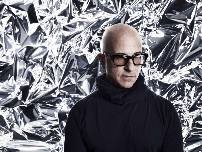 Stephen Petronio wearing large sunglasses in front of a chrome background