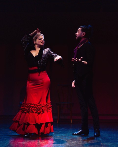 Flamenco dancer with a red skirt and singer with a black suit
