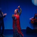 A Flamenco dancer in a polka dot dress and with a red shawl