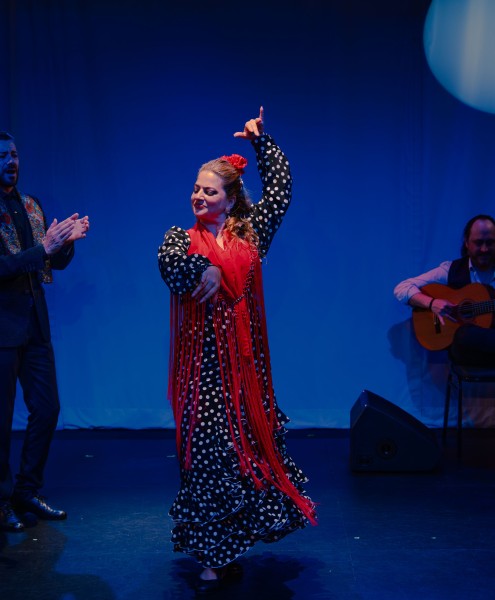 A Flamenco dancer in a polka dot dress and with a red shawl