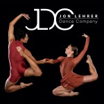 2 dancers jumping with bent legs and rounded arms