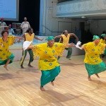 A company photo of Maimouna Keita African Dance Company performing.
