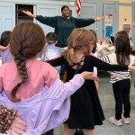 Image of dance teacher in front of a class of Kindergarden students during a Creative Dance class warm up