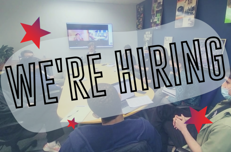 Large text in a transparent white bubble reads "WE'RE HIRING" surrounded by three red stars of various sizes. There is a video l