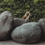 MIngled amongst circular boulders engraved with poems, a dancer (s) emerges from the stillness of the crevices that they create