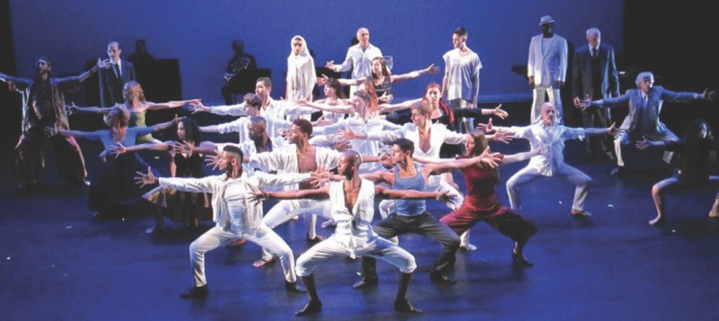 Dancers in white extending through second position 