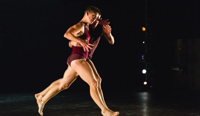 Jennifer Nugent and Paul Matteson running together in tandem on stage.