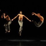 7 dancers leaping in dark brown Ted Shawn pants