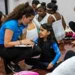 Program Coordinator backstage with dance student