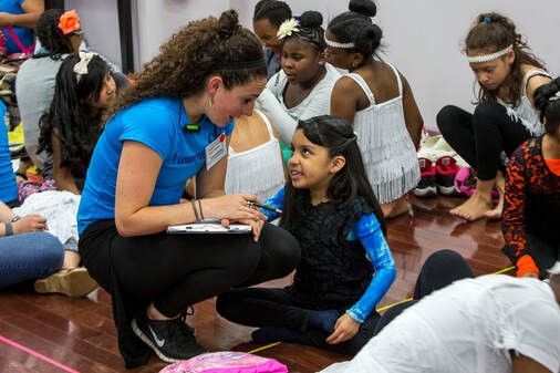 Program Coordinator backstage with dance student