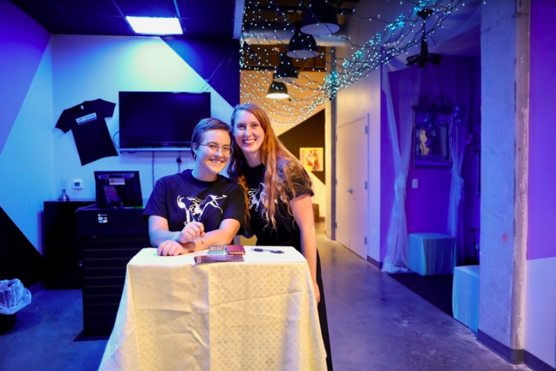 Photo of two young women standing at the podium greeting guests at the Two Can Do Gala 2019