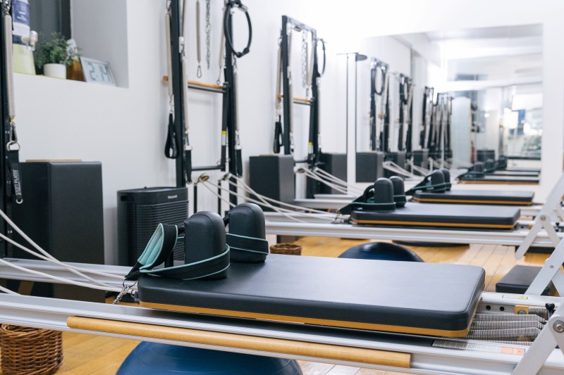 Up close photo of reformers in a Pilates studio
