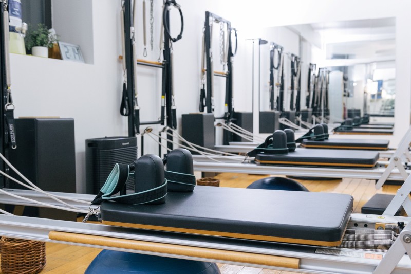 Up close photo of reformers in a Pilates studio