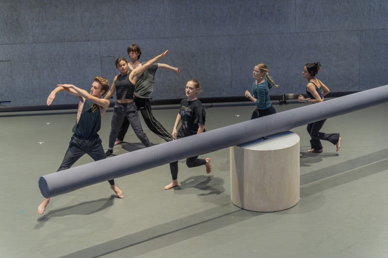 A group of dancers perform on stage.