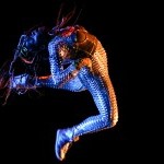 dancer jumping in front of black background