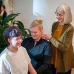 Students work together on Alexander technique, guided by a teacher