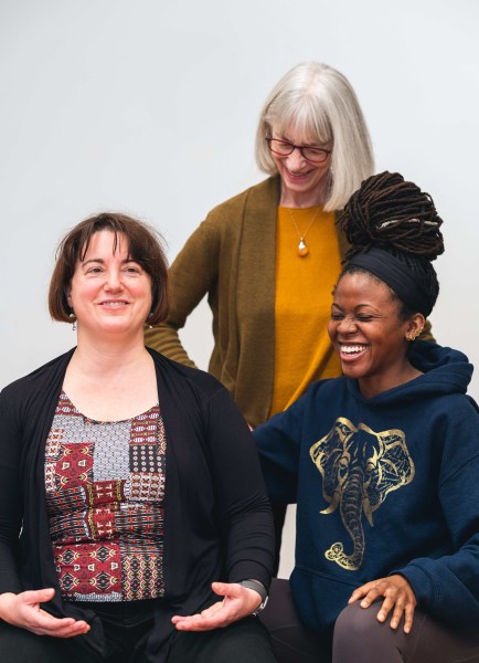 Teacher guiding students as they smile and laugh