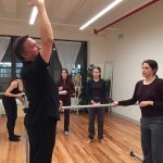 a teacher demonstrates a back cambre in a class at the Balance Arts Center