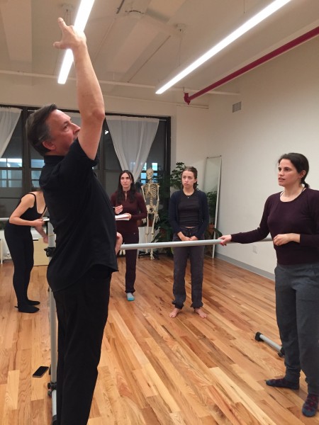 a teacher demonstrates a back cambre in a class at the Balance Arts Center