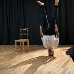 A performer stands on his head during a performance in the Balance Arts Center's Karl Kemp Performance Space