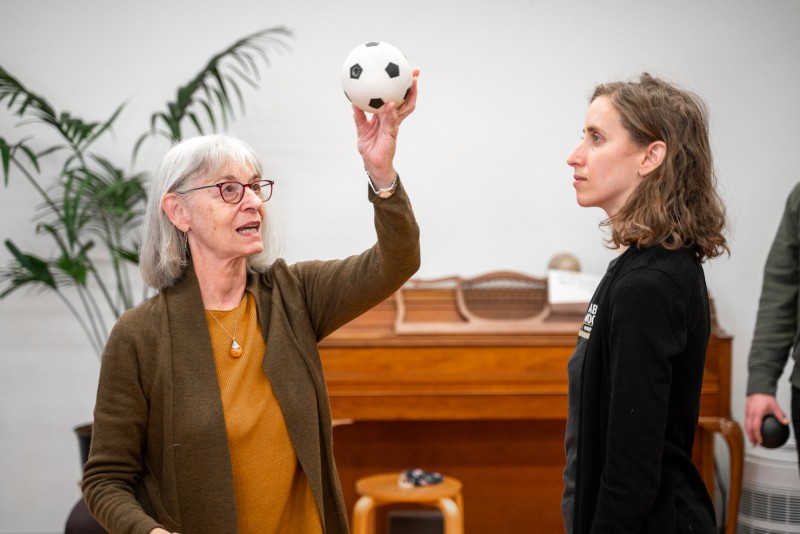 Ann Rodiger holds a small ball that she and a student look at during a class at the Balance Arts Center