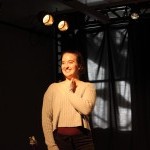 An actor smiles at the audience while performing a monologue at a Balance Arts Center Performance Showcase
