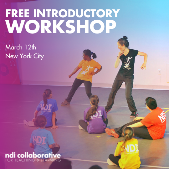 A teacher and a student dancing in front of a group of students. 